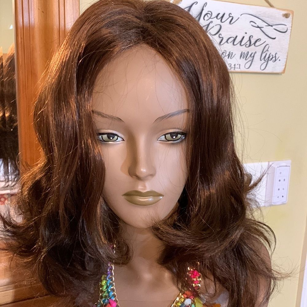 Brown wavy wig. Combs smoothly like hair.  Not sure if it's real/synthetic.